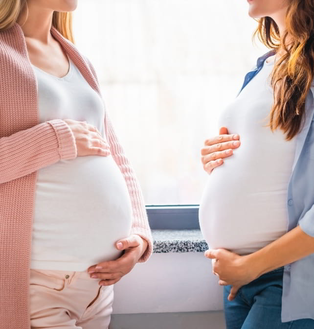 cropped-view-of-smiling-pregnant-women-standing-by-2021-08-30-02-15-56-utc